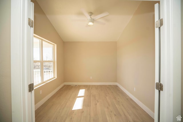 empty room featuring lofted ceiling, light hardwood / wood-style flooring, and ceiling fan