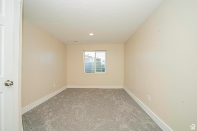 spare room featuring light colored carpet