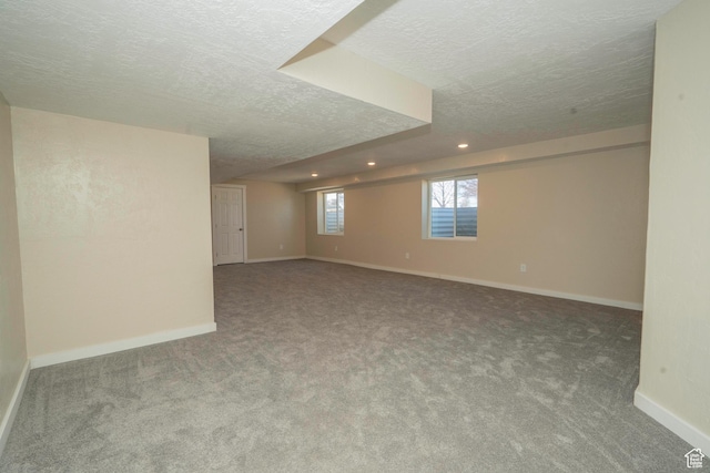 basement featuring carpet floors and a textured ceiling