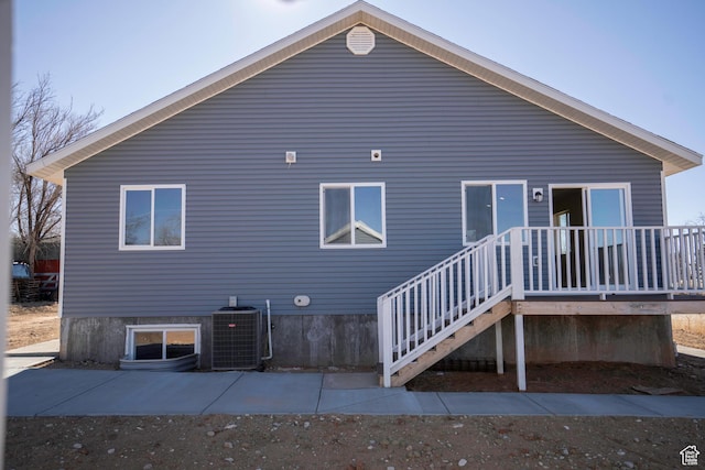 rear view of house with central air condition unit