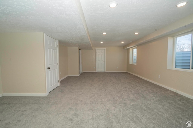 basement with light carpet and a textured ceiling