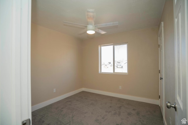 unfurnished room with ceiling fan and dark colored carpet