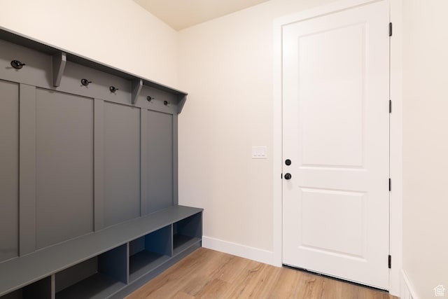 mudroom with baseboards and light wood-style flooring