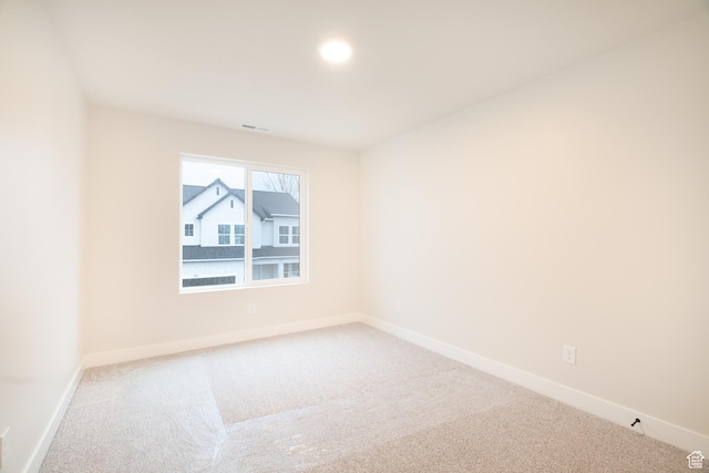 empty room with visible vents, carpet flooring, and baseboards