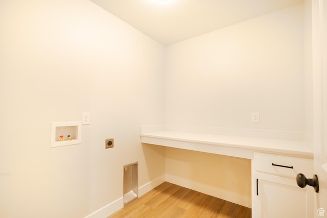 washroom featuring light wood-style floors, baseboards, cabinet space, washer hookup, and hookup for an electric dryer