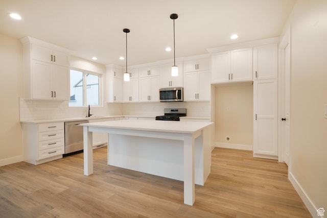 kitchen featuring light countertops, stainless steel appliances, baseboards, and tasteful backsplash