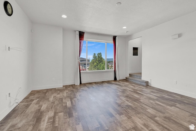 1726 W Thira Ln S, South Jordan, UT 84095 - unfurnished room with wood finished floors, baseboards, recessed lighting, and a textured ceiling