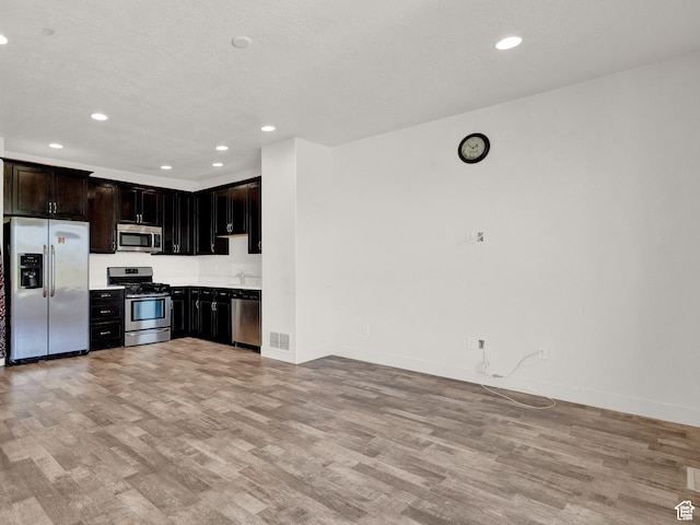 1726 W Thira Ln S, South Jordan, UT 84095 - kitchen featuring stainless steel appliances, light wood-type flooring, recessed lighting, baseboards, and light countertops