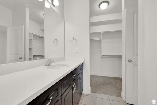 1726 W Thira Ln S, South Jordan, UT 84095 - bathroom featuring a walk in closet, vanity, baseboards, and tile patterned floors