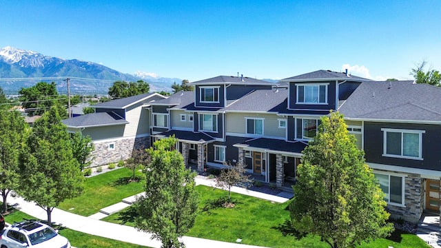1726 W Thira Ln S, South Jordan, UT 84095 - view of front of house featuring stone siding, a residential view, a front lawn, a mountain view, and cooling unit