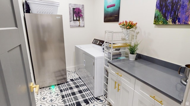 washroom with cabinets and separate washer and dryer