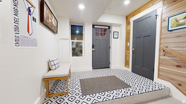 foyer entrance featuring wood walls