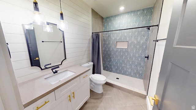 bathroom with vanity, curtained shower, tile patterned floors, and toilet
