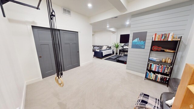 interior space with beamed ceiling and carpet flooring