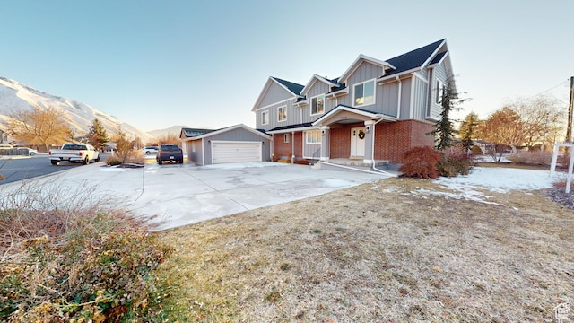 view of front of property with a garage and a mountain view
