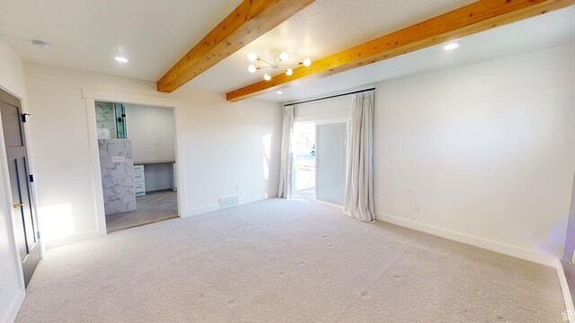 carpeted spare room featuring beamed ceiling