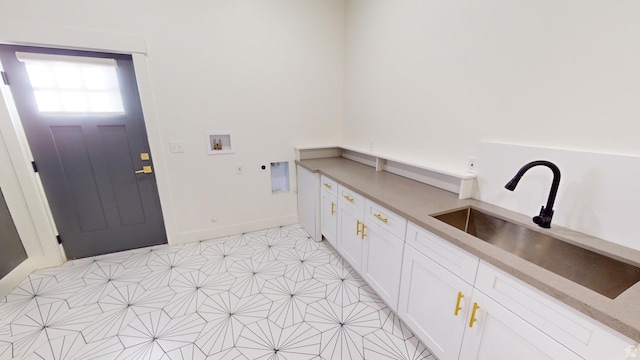 clothes washing area with cabinets, washer hookup, and sink