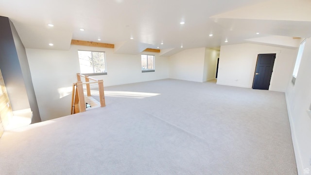interior space featuring light carpet and vaulted ceiling