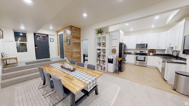 dining area with sink and light wood-type flooring