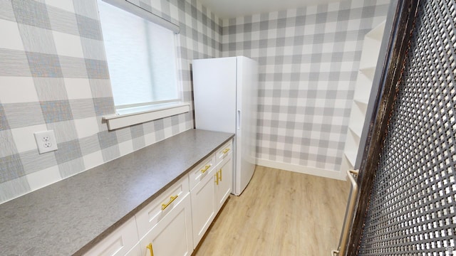 kitchen featuring white fridge, white cabinets, and light wood-type flooring