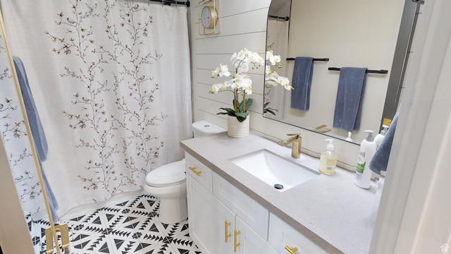 bathroom featuring vanity, toilet, and curtained shower