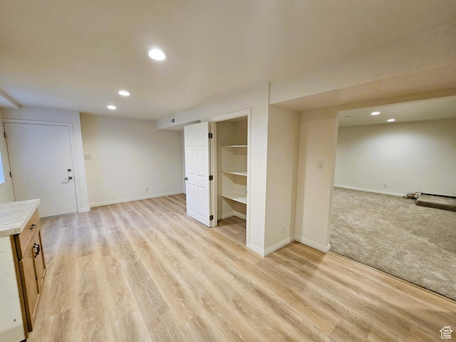 interior space with baseboards, recessed lighting, and light wood finished floors