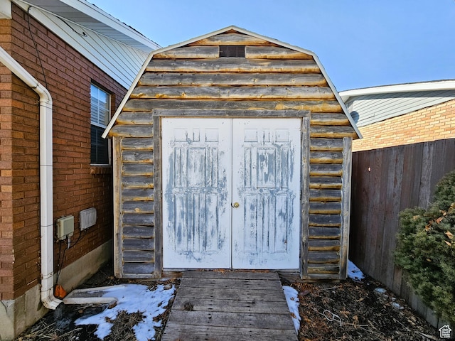 view of shed featuring fence