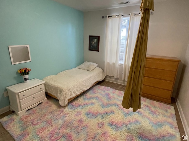 bedroom with visible vents and baseboards