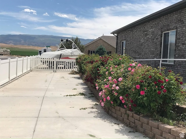 view of patio featuring fence and a mountain view