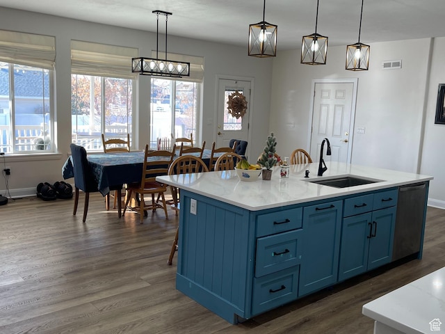 kitchen with visible vents, dishwasher, dark wood-style floors, light countertops, and a sink