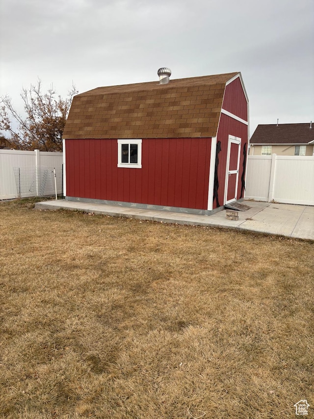view of shed featuring fence