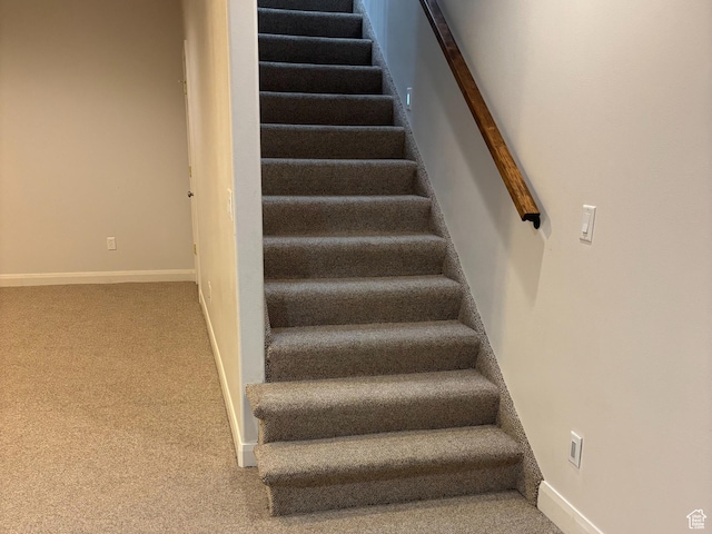 staircase with carpet floors and baseboards