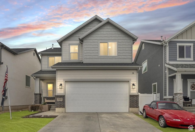 craftsman-style home featuring a garage and a lawn