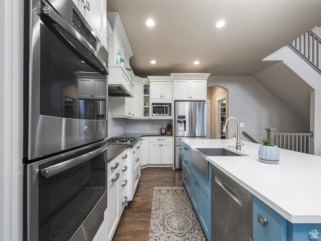 2654 E Water Wheel Ct, Heber City, UT 84032 - kitchen with blue cabinetry, sink, a center island with sink, stainless steel appliances, and white cabinets