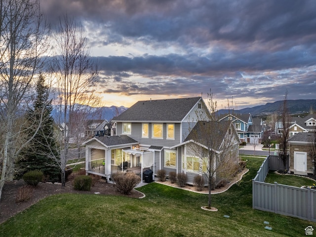 2654 E Water Wheel Ct, Heber City, UT 84032 - back house at dusk featuring a mountain view and a lawn