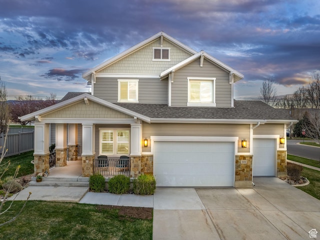 craftsman inspired home with a porch and a garage