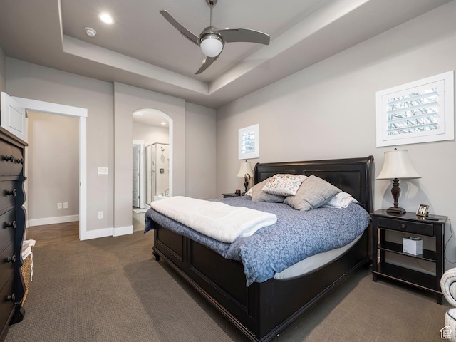 2654 E Water Wheel Ct, Heber City, UT 84032 - bedroom featuring connected bathroom, a tray ceiling, ceiling fan, and dark colored carpet