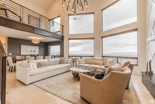 1555 Aerie Cir, Park City, UT 84060 - living room with an inviting chandelier, a towering ceiling, light hardwood / wood-style flooring, and a wealth of natural light