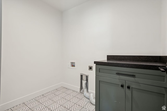 clothes washing area with cabinets, electric dryer hookup, and washer hookup