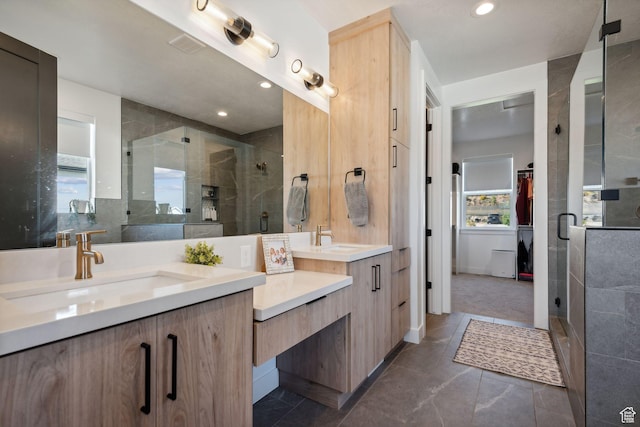 bathroom with vanity and a shower with shower door