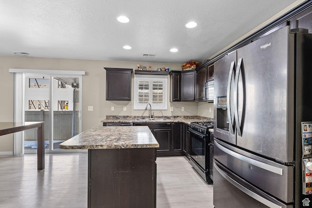 626 S 2310 W, Pleasant Grove, UT 84062 - kitchen featuring a kitchen island, sink, dark brown cabinetry, black appliances, and a textured ceiling