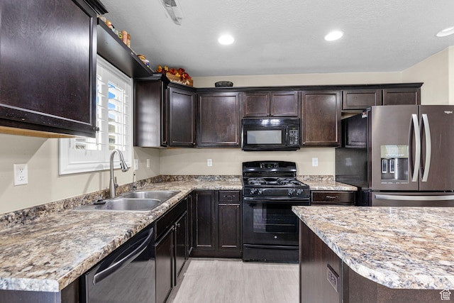 626 S 2310 W, Pleasant Grove, UT 84062 - kitchen featuring sink, a textured ceiling, dark brown cabinets, light hardwood / wood-style floors, and black appliances