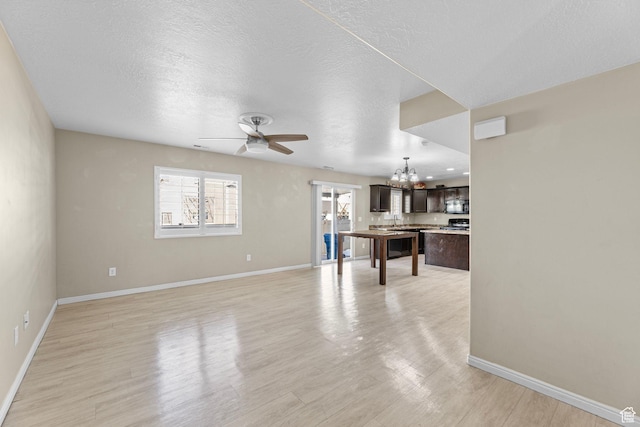 626 S 2310 W, Pleasant Grove, UT 84062 - living room featuring ceiling fan with notable chandelier, light hardwood / wood-style flooring, and a textured ceiling