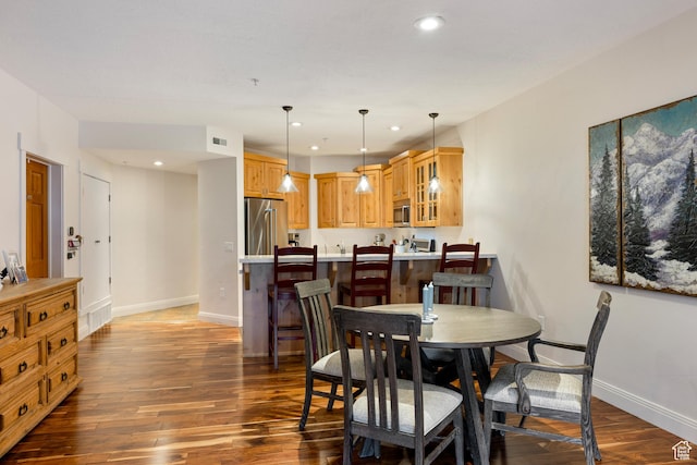 dining space featuring dark hardwood / wood-style floors