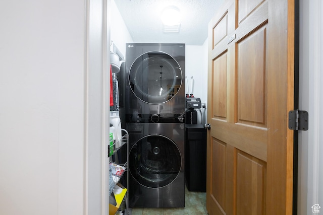 laundry room featuring stacked washer and clothes dryer