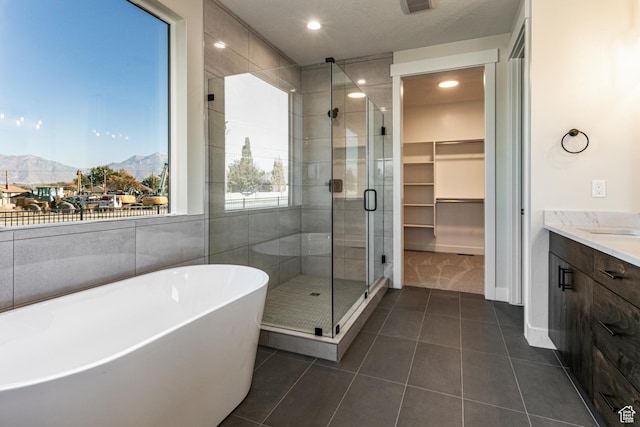 11202 S 1000 E Unit 3, Sandy, UT 84094 - bathroom featuring vanity, shower with separate bathtub, a mountain view, and tile patterned flooring