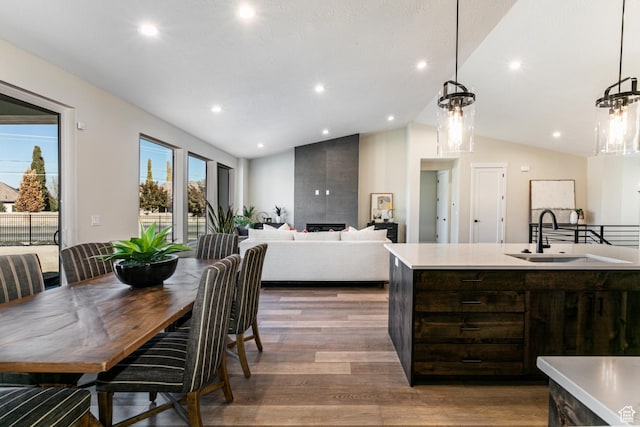 11202 S 1000 E Unit 3, Sandy, UT 84094 - kitchen featuring dark brown cabinets, sink, light hardwood / wood-style flooring, and decorative light fixtures