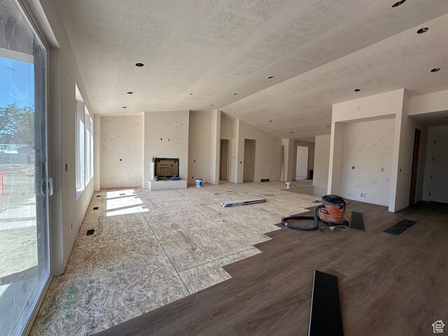 11202 S 1000 E Unit 3, Sandy, UT 84094 - unfurnished living room featuring healthy amount of natural light, wood finished floors, a textured ceiling, and vaulted ceiling