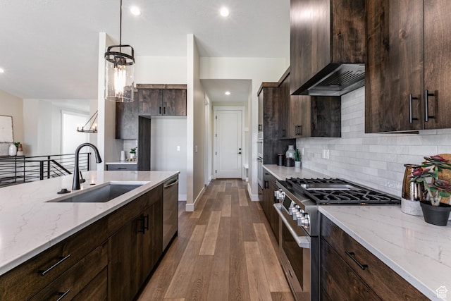 11202 S 1000 E Unit 3, Sandy, UT 84094 - kitchen with wood-type flooring, sink, hanging light fixtures, stainless steel appliances, and light stone countertops