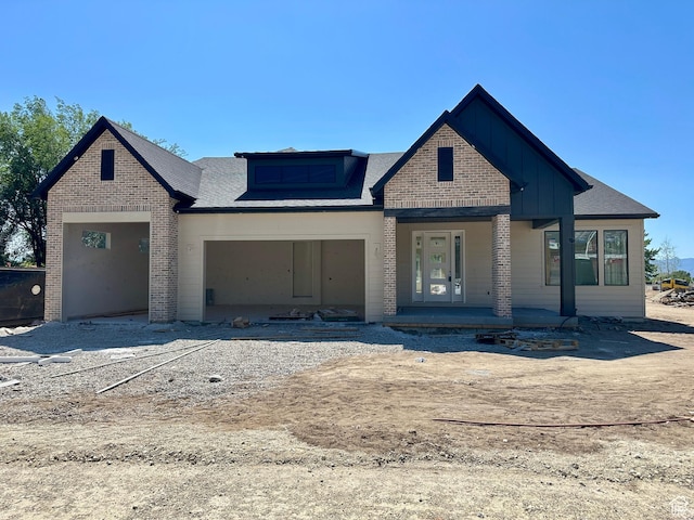 11202 S 1000 E Unit 3, Sandy, UT 84094 - view of front facade with board and batten siding, a porch, an attached garage, and brick siding